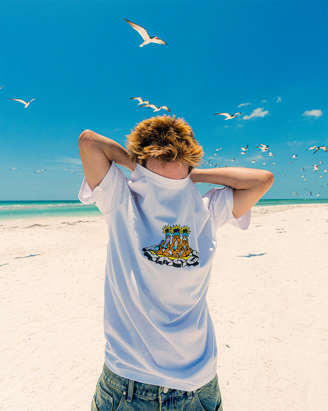 Still Photograph on beach with man covering his face with shirt; from Plague Boulevard's 2025 Sunburn Collection shot by Collin 2kcol McMinn